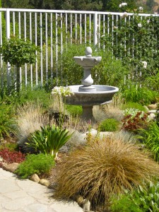 Ornamental grasses surround a two-tiered fountain
