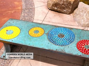 Closeup of mosaic tile bench with metal
