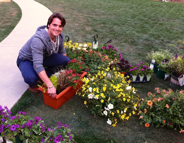 Nick Birren, producer at Home and Family Show gets involved in the deck makeover segment by unloading plants and soil. 