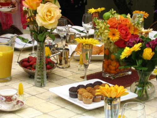 Outdoor Table Setting with tile table, roses, muffins and fresh fruit